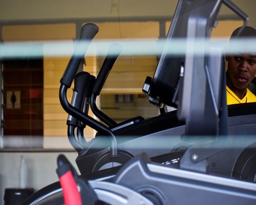 Trainer assisting with a fitness machine
