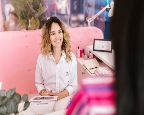 Receptionist smiling at the front desk